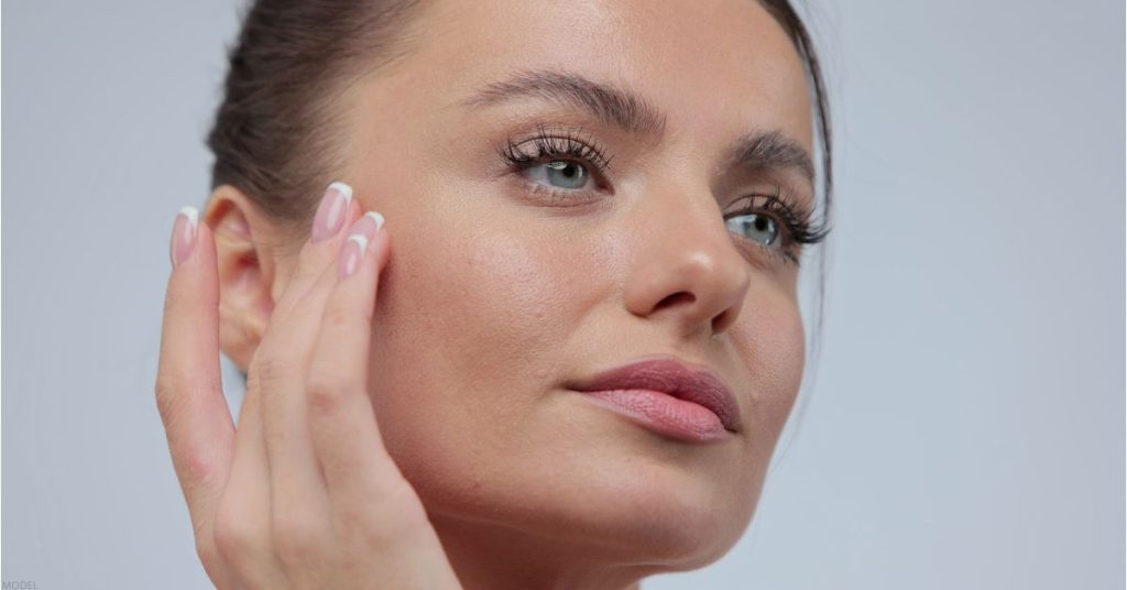 Woman touching her face (model)